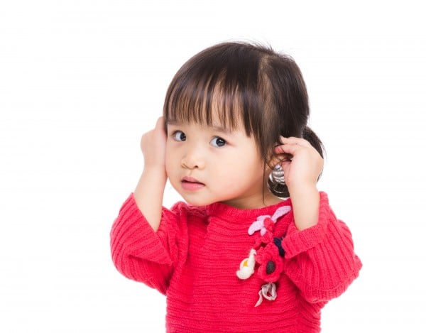 Asia little girl touch her ear