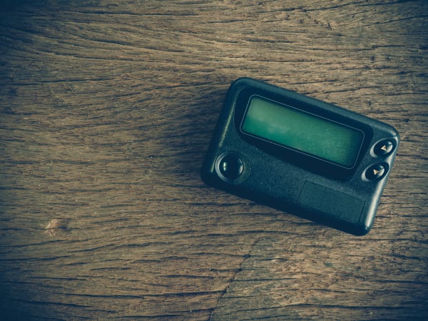 Old pager device on wooden table