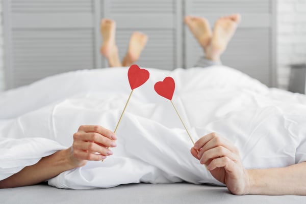 Man and woman relaxing together in bedroom