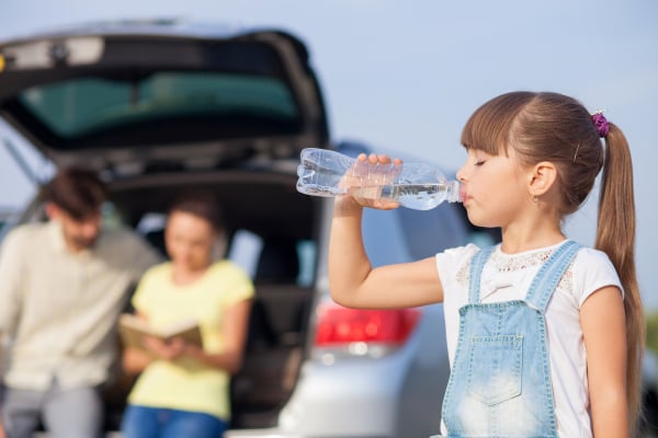 Cheerful family is resting near vehicle outdoor