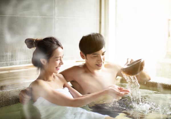 Young couple relaxing in hot springs